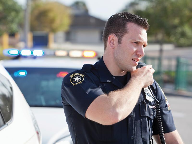 a law enforcement officer talking on a radio